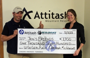 Jen’s Friends President Corinne Reidy accepts a $1,700 donation from Attitash Race and Events Manager Corey Madden